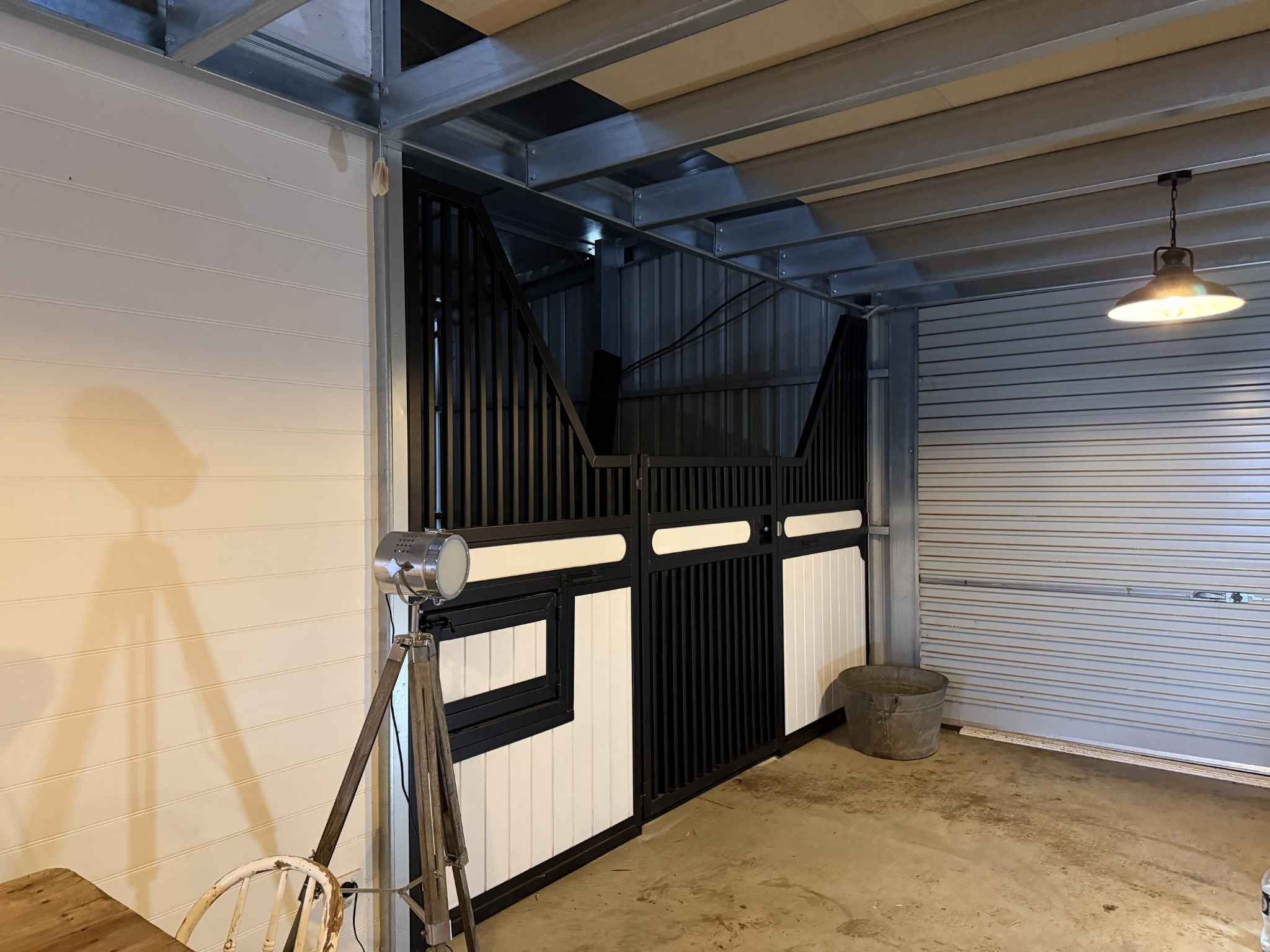 Black and white custom Elite Series stable front fitted inside Kerry's existing shed